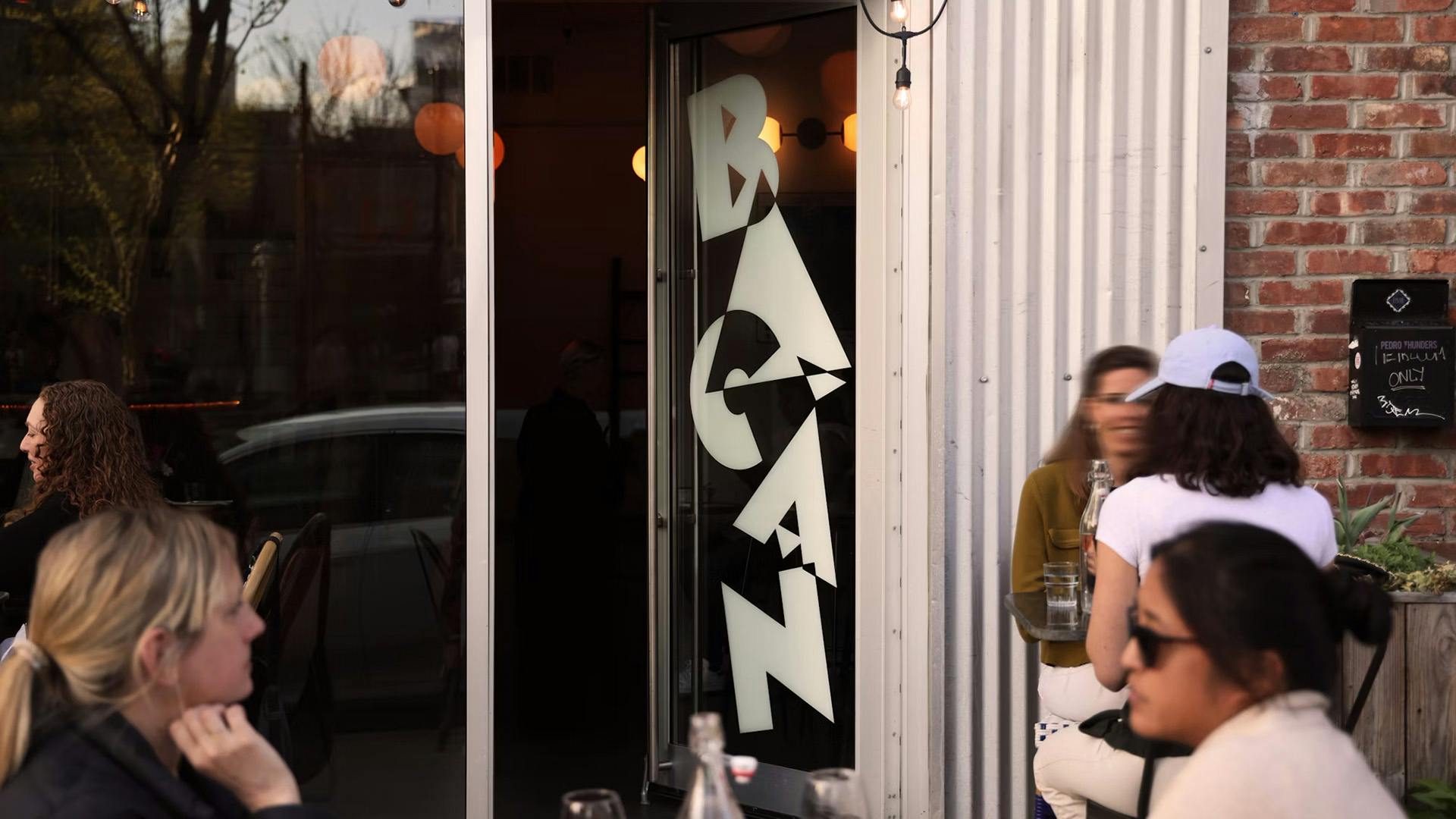 The restaurant name Bacan displayed on a window