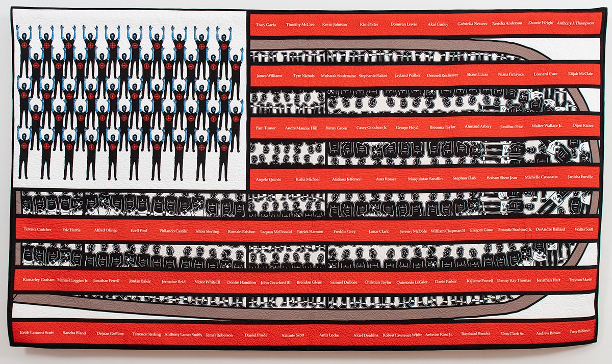 Couette noire, rouge et blanche avec des personnages noirs et des rangées de noms en forme de drapeau américain