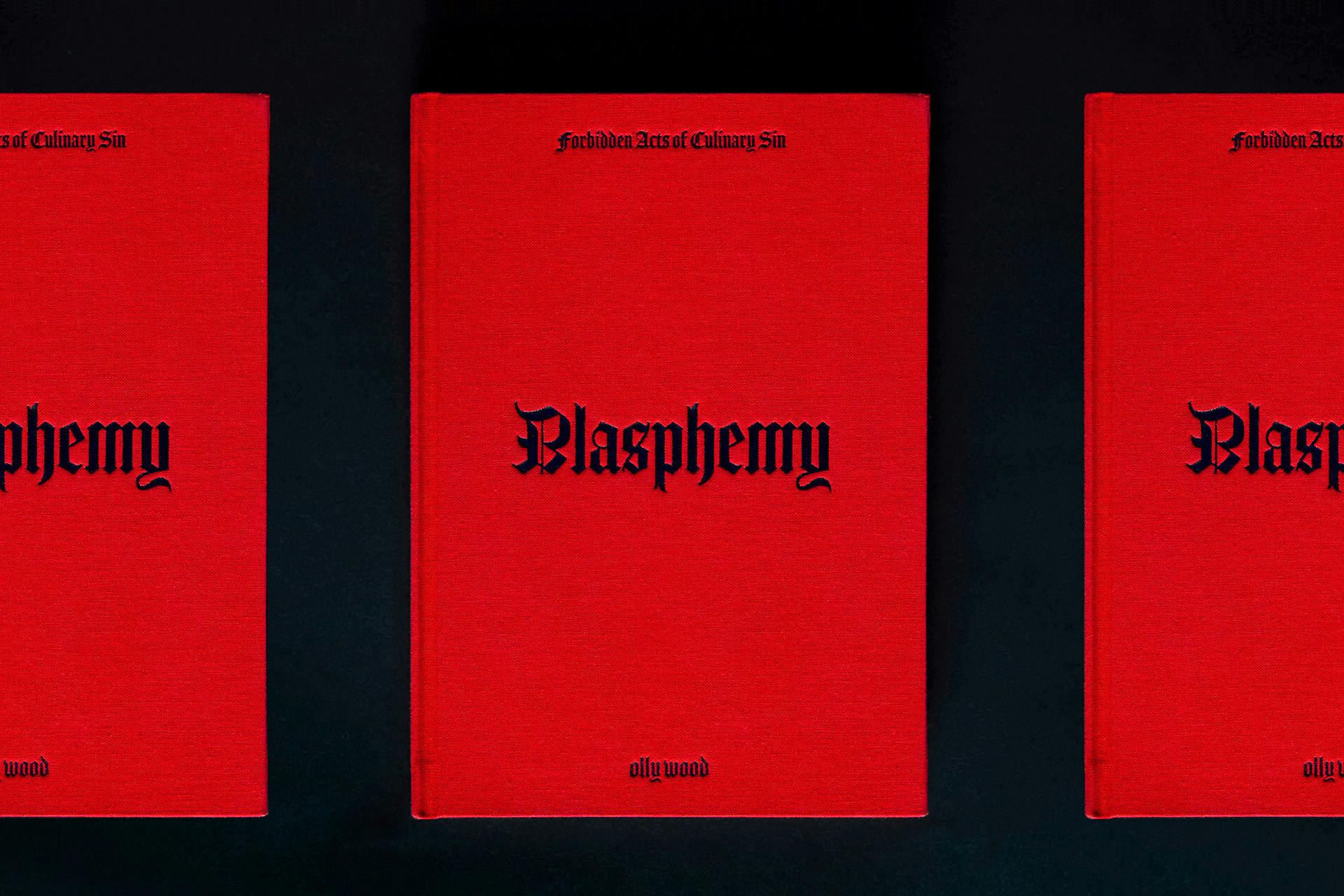 Row of three cookbooks with a read cover headlined 'blasphemy' in Gothic font